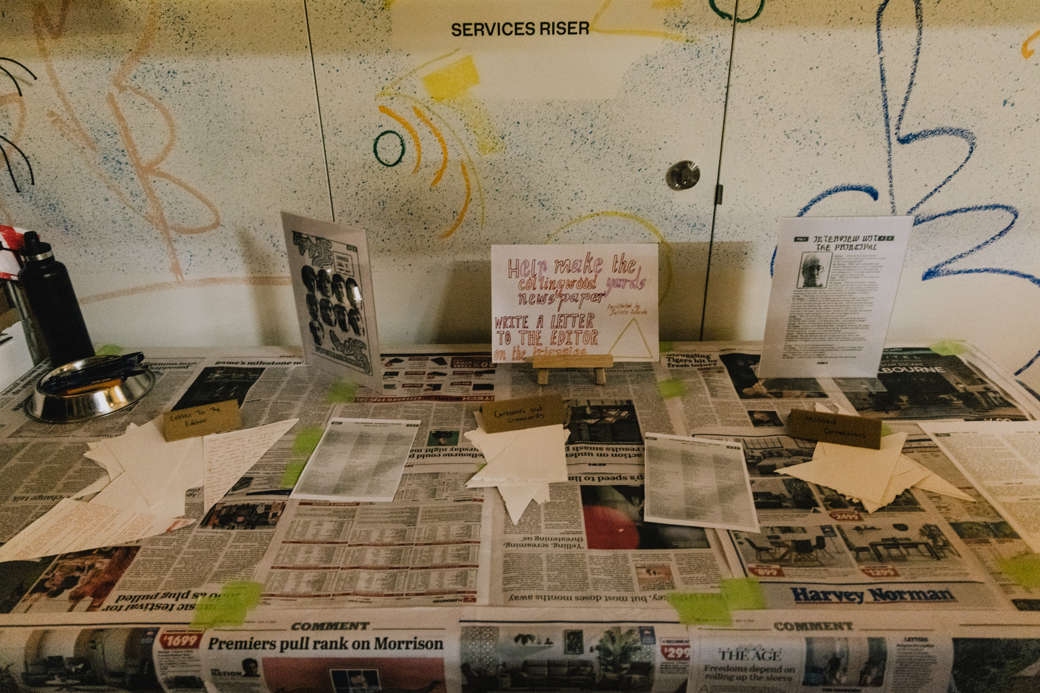 a table covered in newspaper with notes and signs